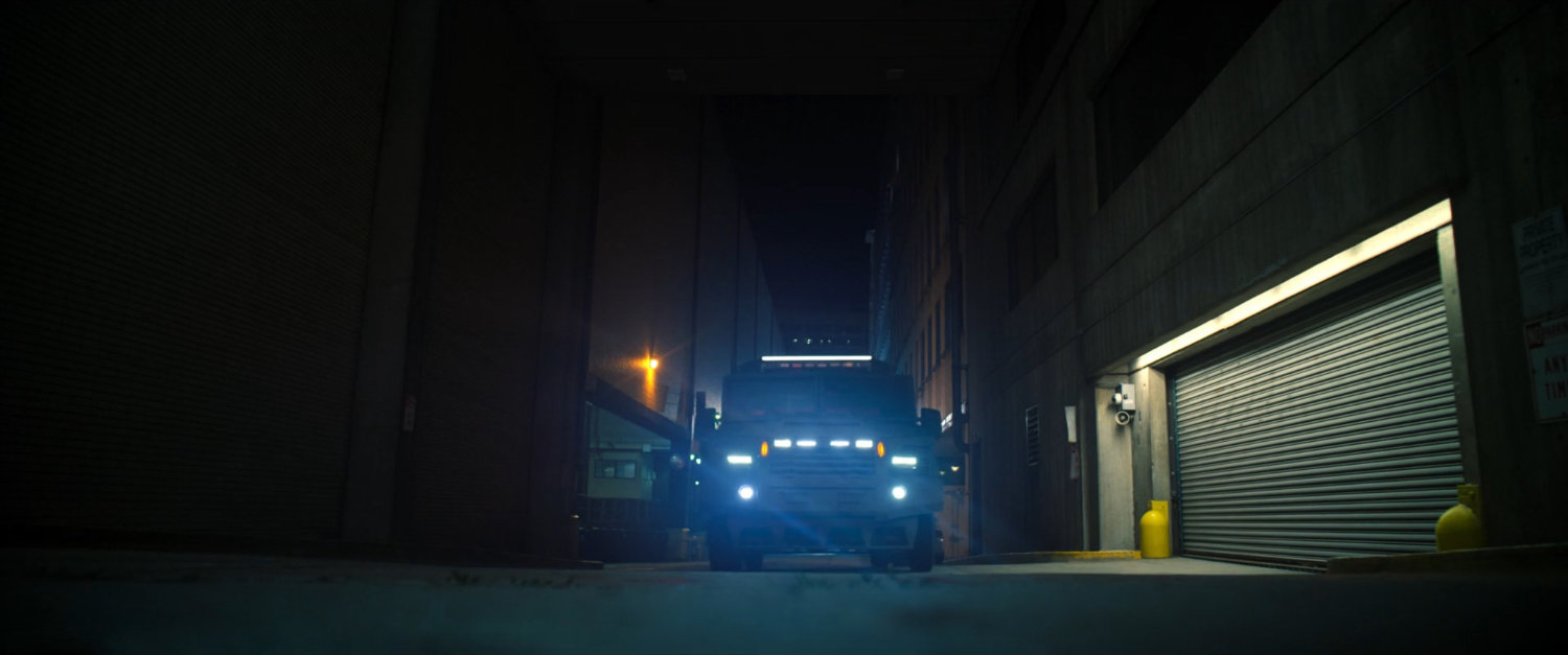 Armored car in a dark New York alley.