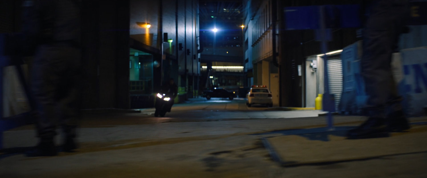 A dark New York alley.