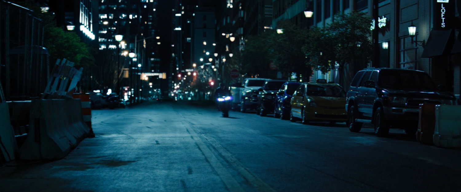 A motorcycle on a dark New York street.