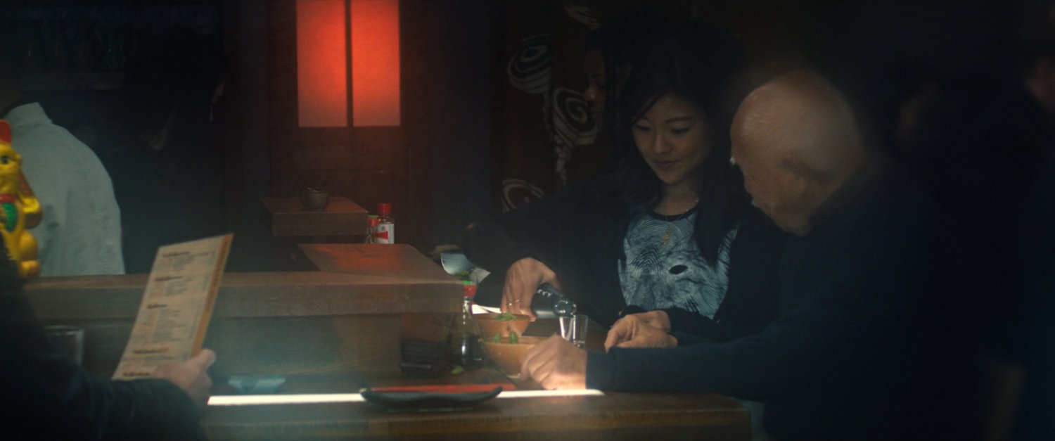 Mr. Nakajima and Leah in a sushi restaurant.