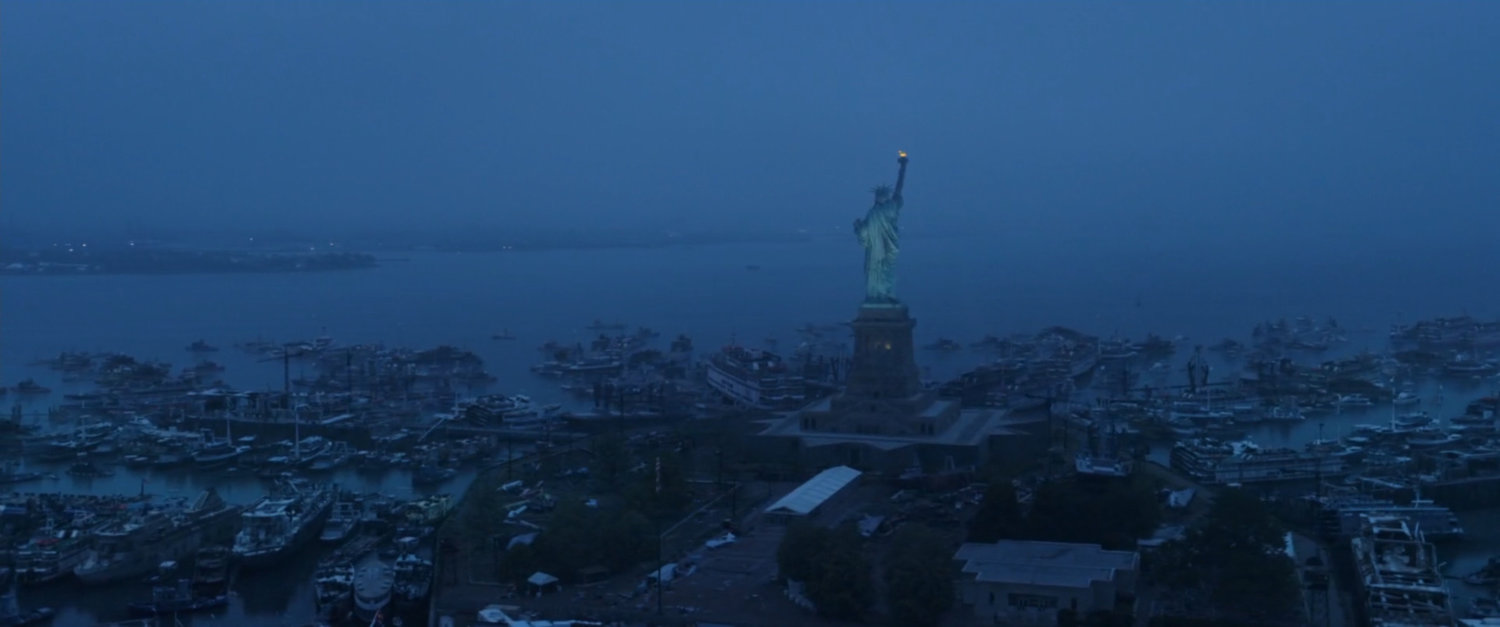Aerial image of Statue of Liberty with hundreds of boats parked around the island.