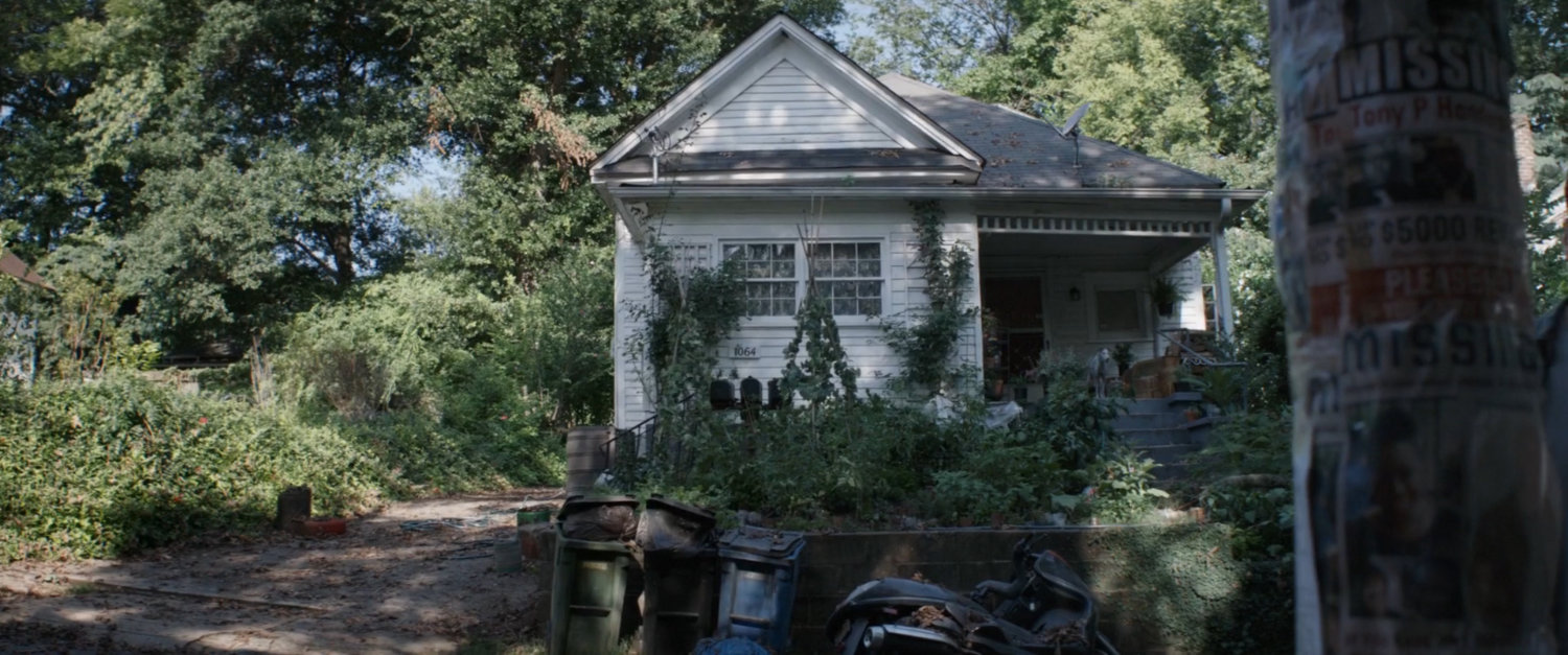 A run down and overgrown house.