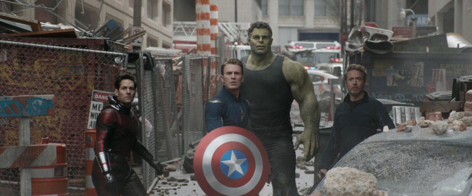 Scott, Steve, Smart Hulk, and Tony stand in a A rubble strewn alley in New York.