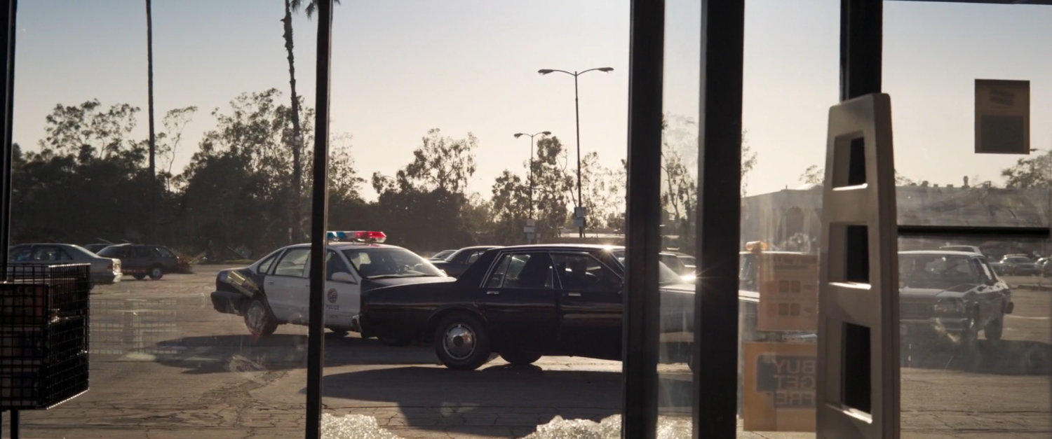 Law enforcement card pull up outside a Blockbuster Video.