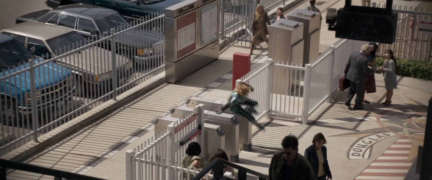 Vers leaps turnstyle at Los Angeles metro station.