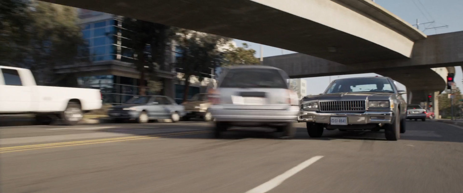 Nick Fury's car taps an oncoming car bumper on Los Angeles street.
