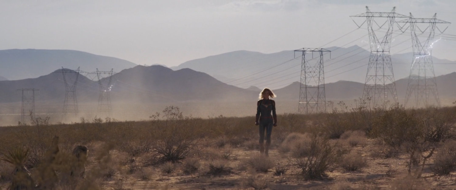 Captain Marvel walking across the desert.