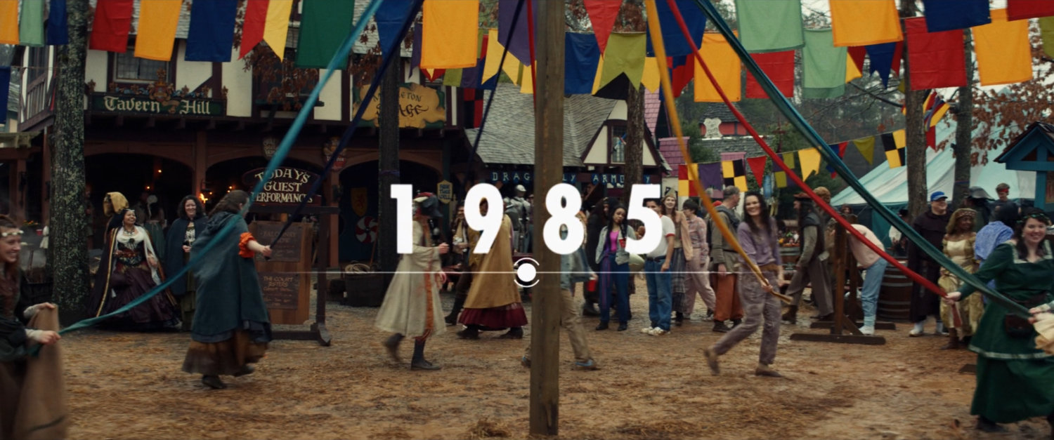 People dancing around may pole at Renaissance Faire. Text: 1985.