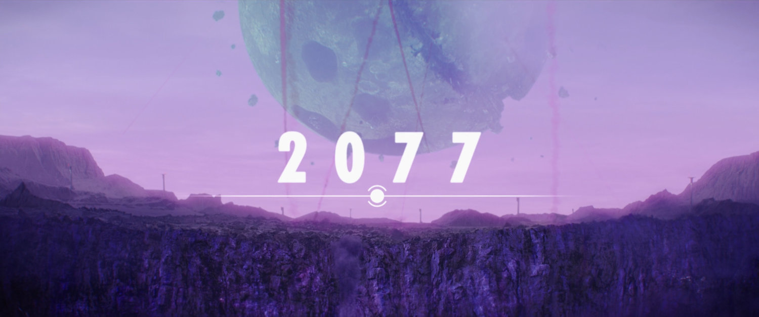 View of moon breaking up in alien atmosphere. Text: 2077.