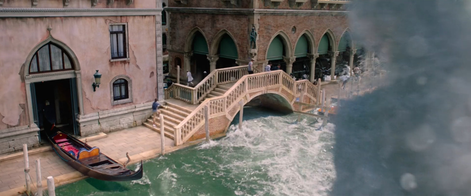 Rough waters wash under a small bridge on a Venice canal.