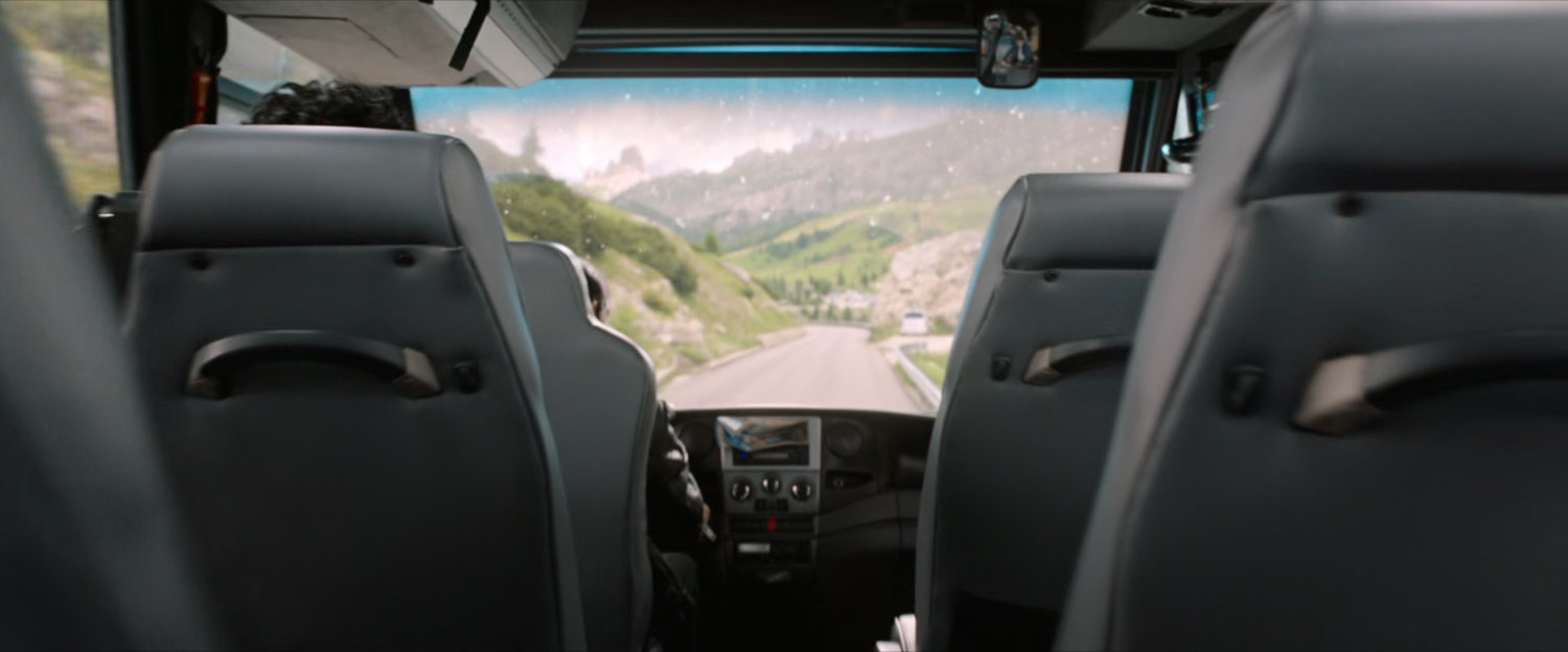 POV from inside tour bus on mountain road.