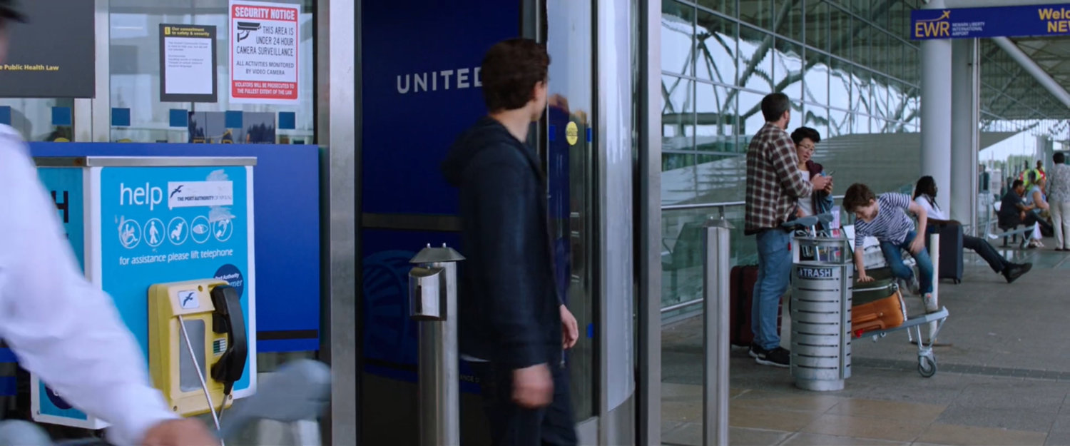Peter exits Newark airport terminal.