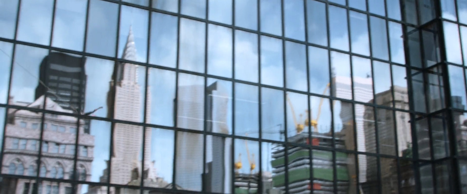 Reflection of New York and Empire State Building in another skyscraper window.