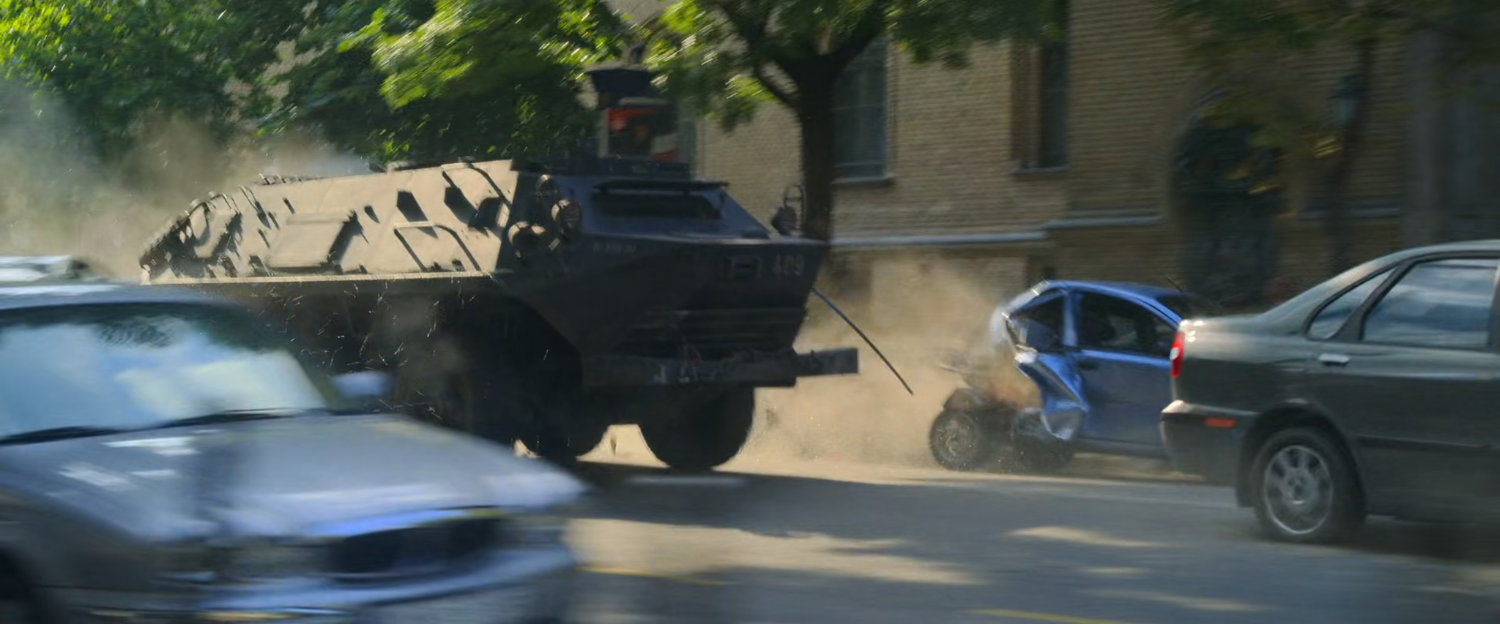 An APC crashes through cars on a Budapest street.