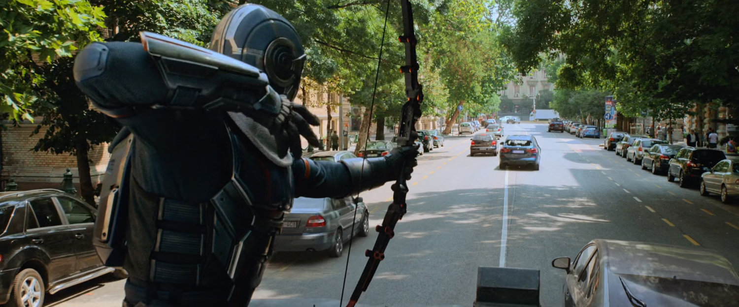 Taskmaster fires an arrow at a small car on a Budapest street.