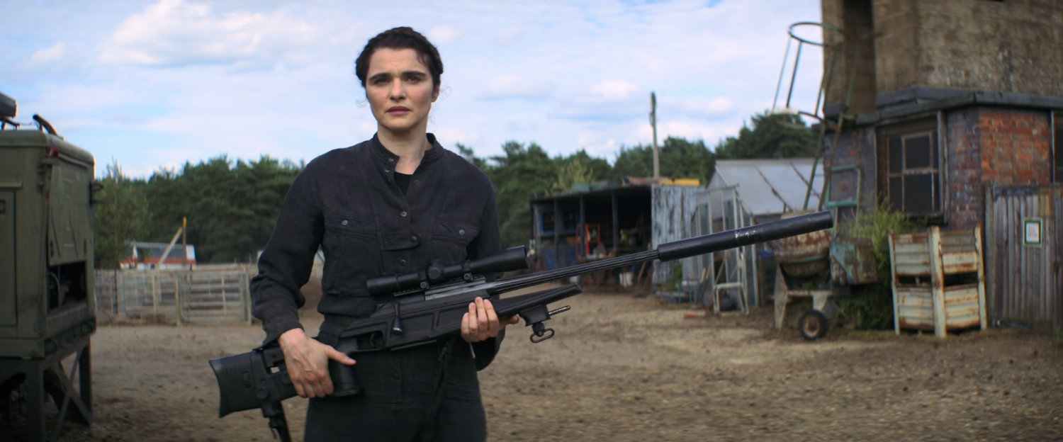 Melina with a rifle outside her homestead.