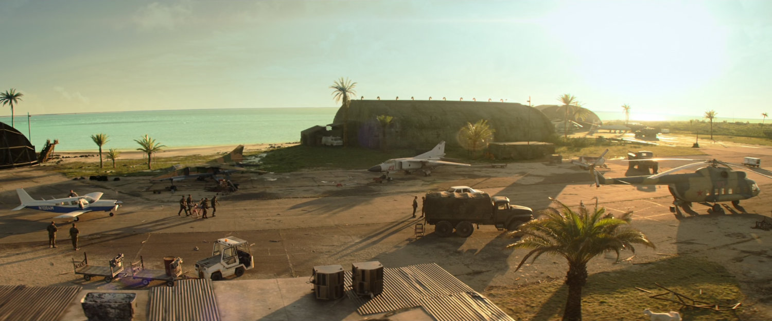 High angle of various planes, helicopters and trucks on a Cuban runway.