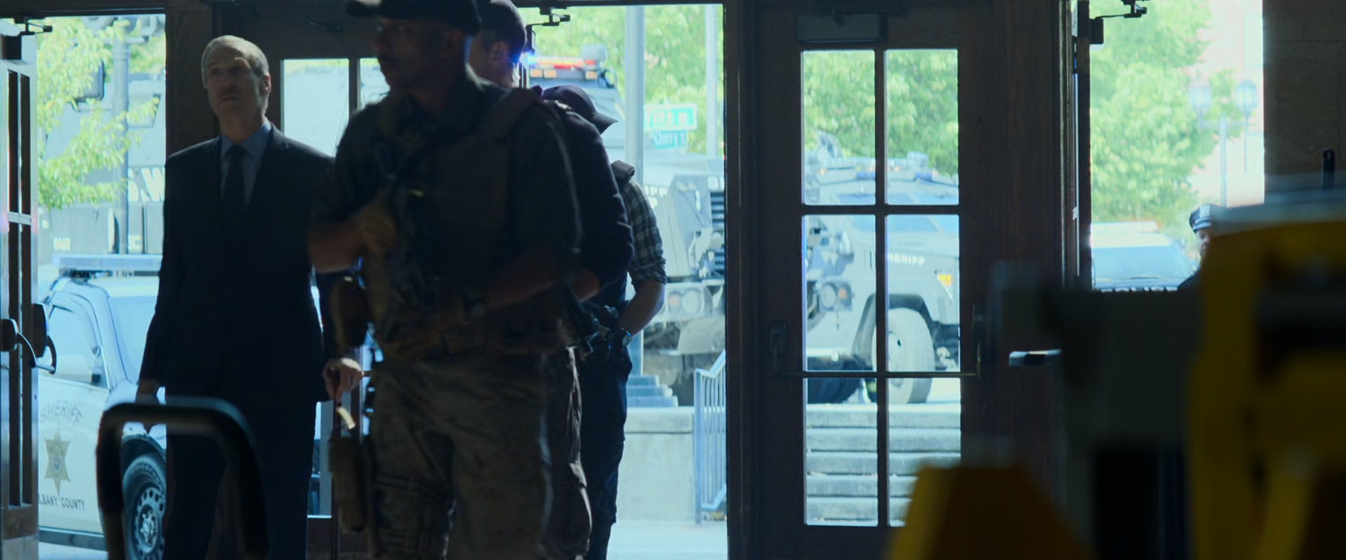 General Ross and some soldiers entering train terminal.
