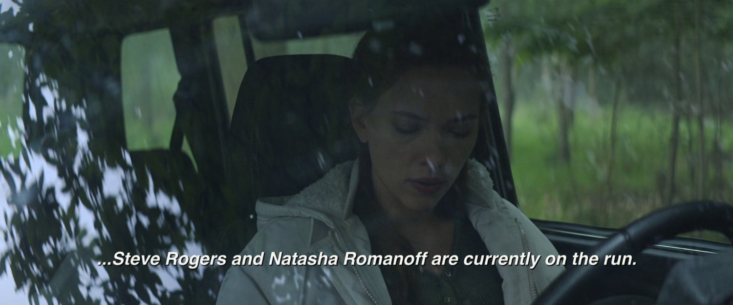 Natasha behind the wheel of a car.