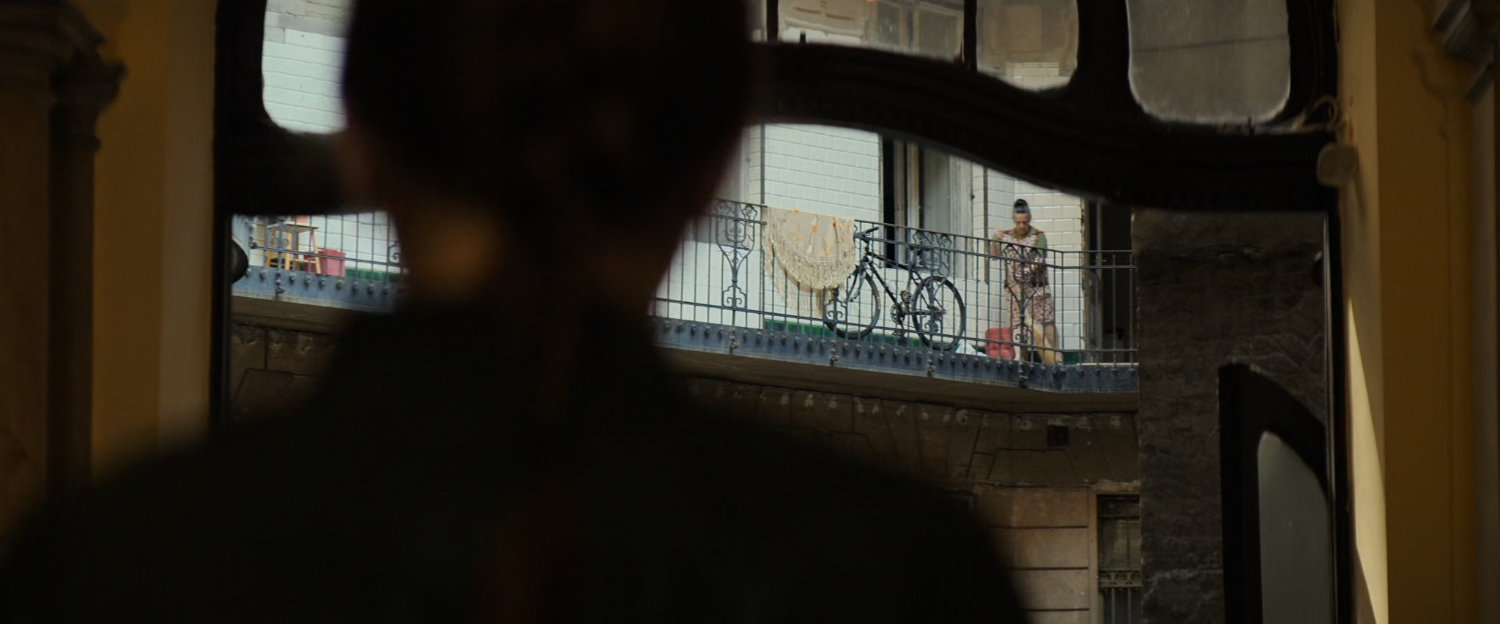 View of apartment balcony over Natasha's shoulder.
