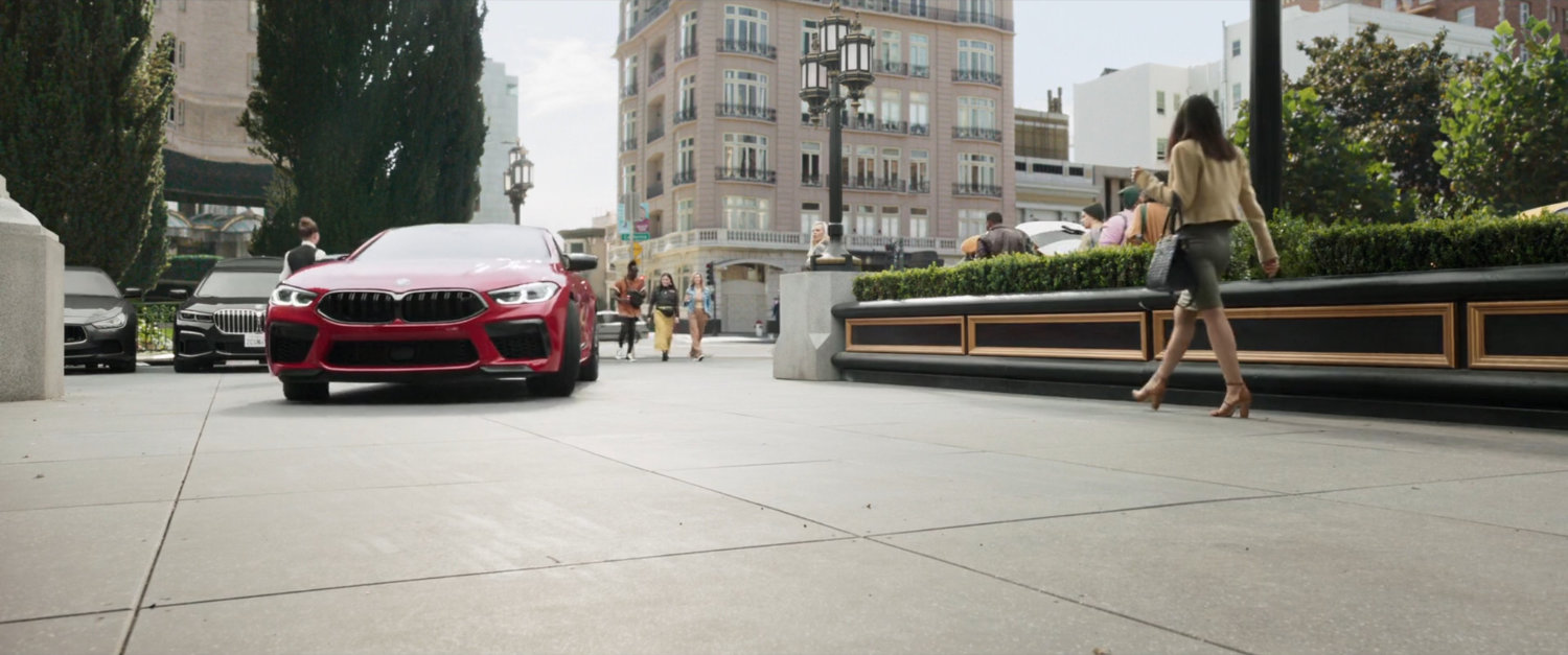 A red car puling up to the Fairmont San Francisco hotel.