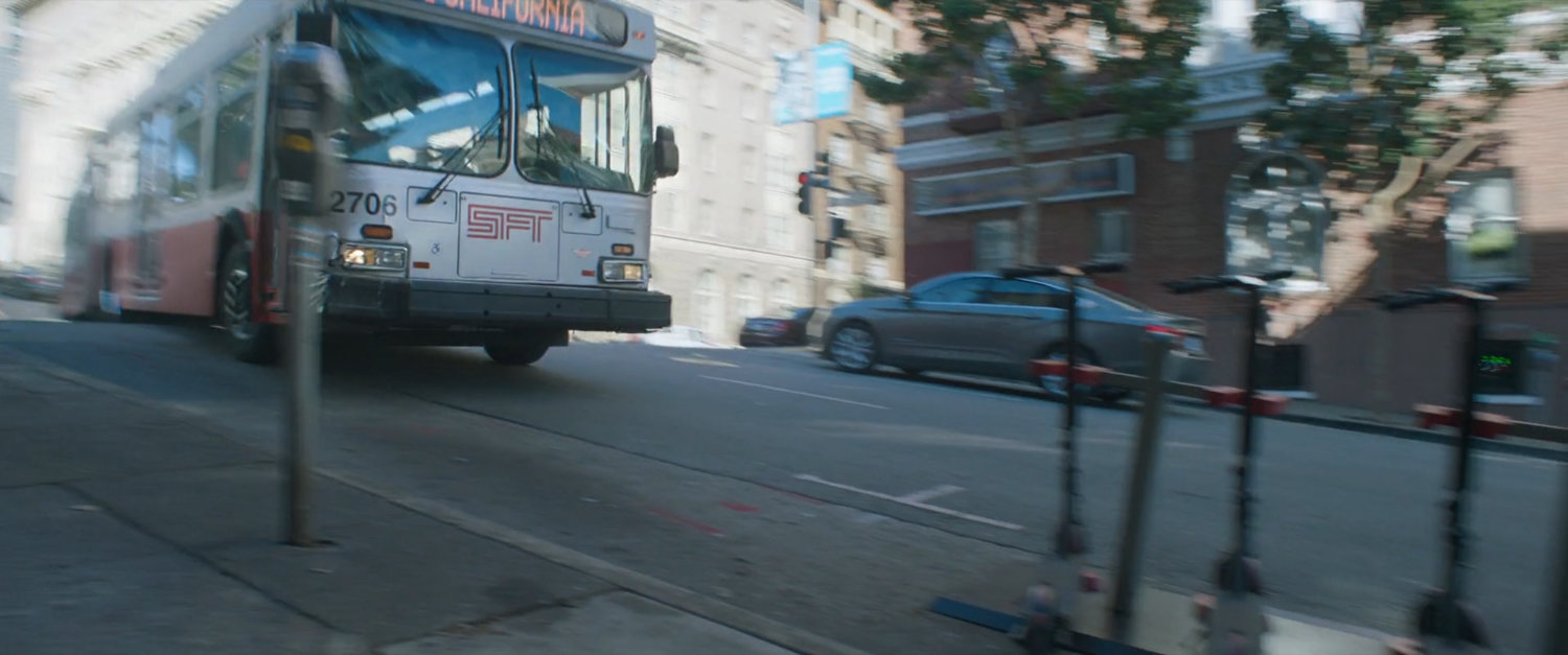 A San Francisco metro bus speeds down a hilly street.
