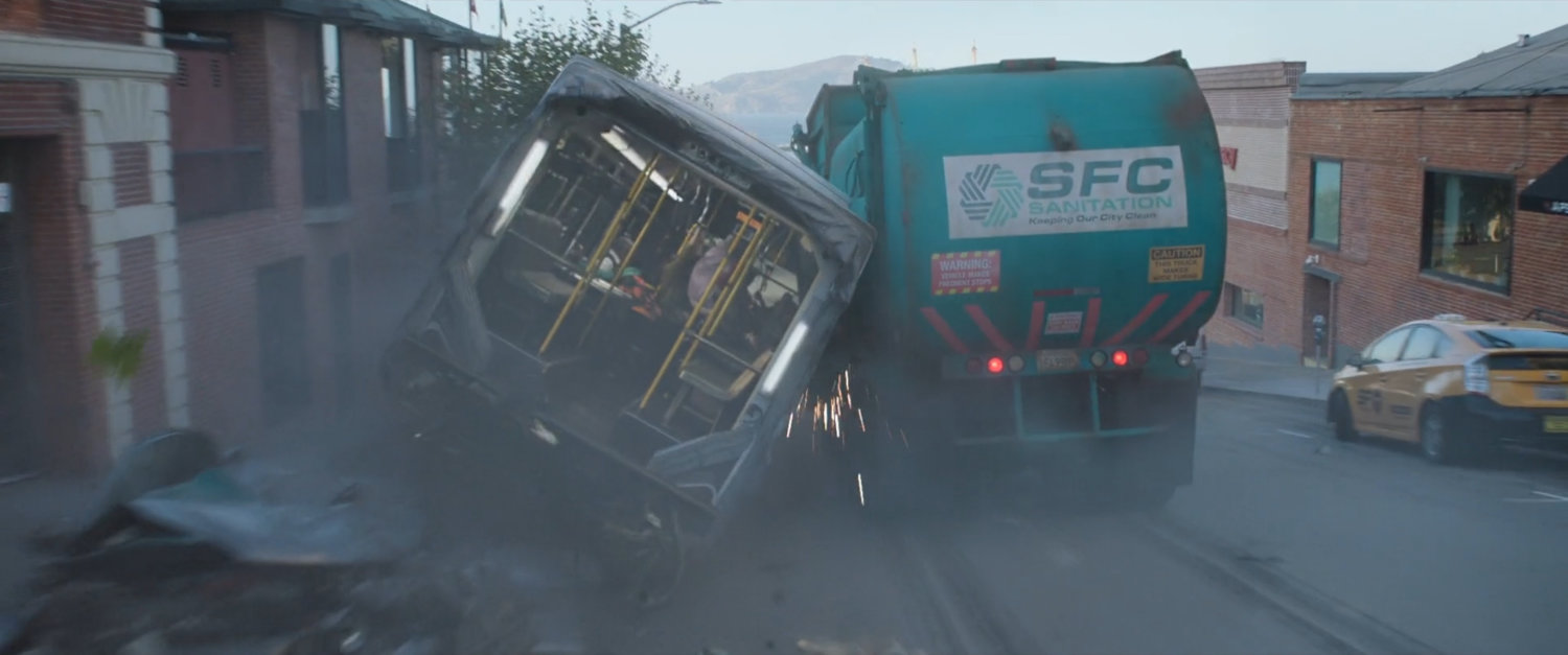 San Francisco trash truck and city bus crashing outside Ghirardelli Square entrance.