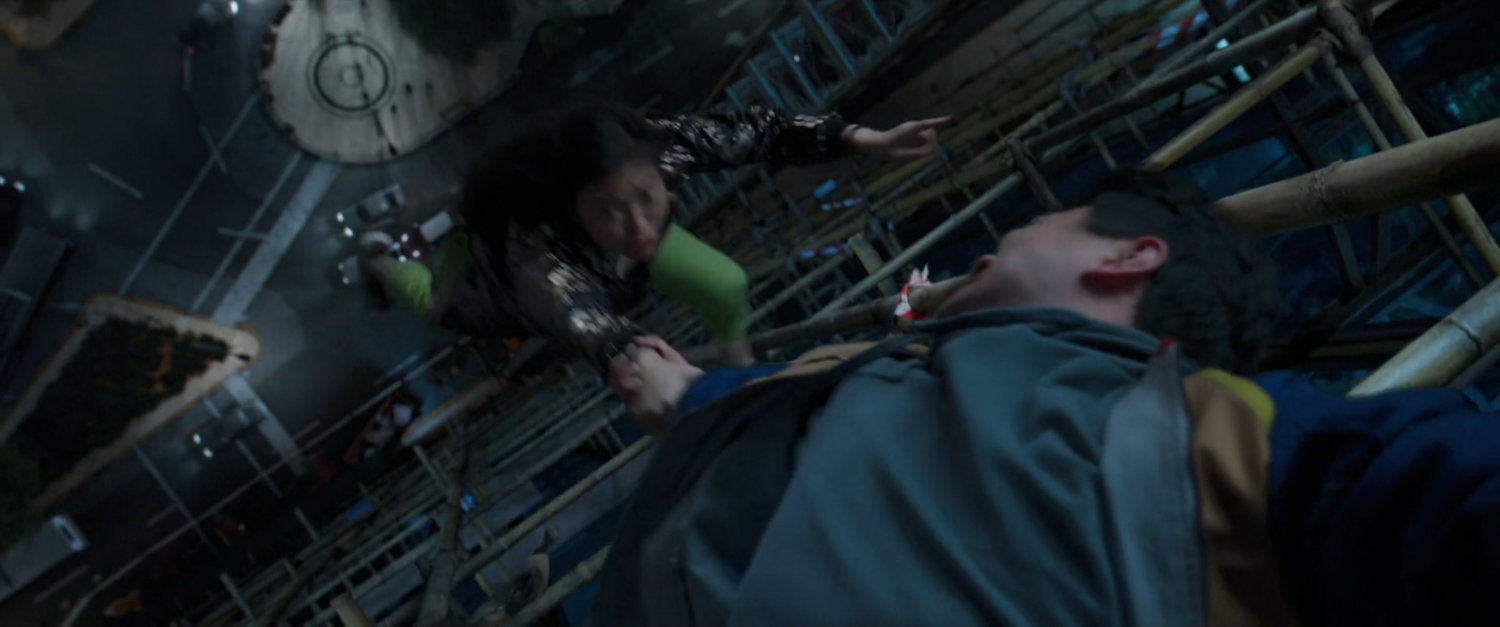 Shaun keeps Katy from falling off skyscraper scaffolding in Macau.