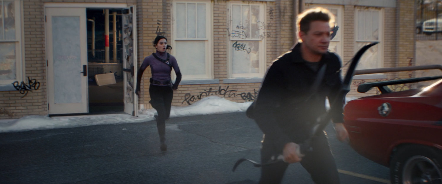 Clint and Kate run from the entrance of an abandoned toy store.