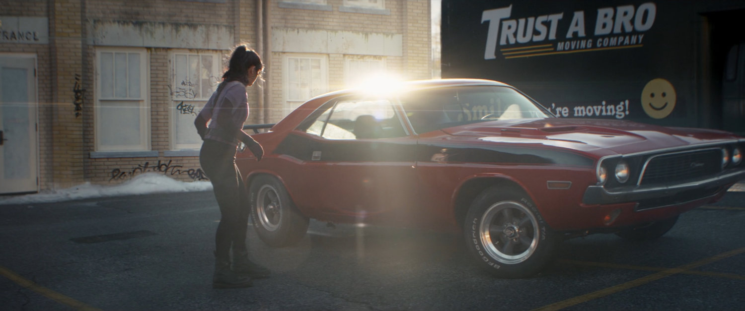 Kate looks at a red Challenger.