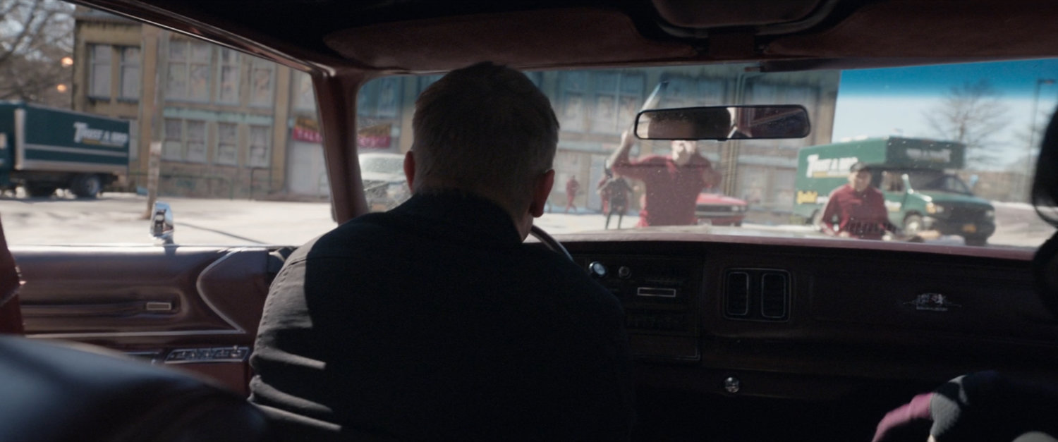 Clint drives away from the abandoned toy store.