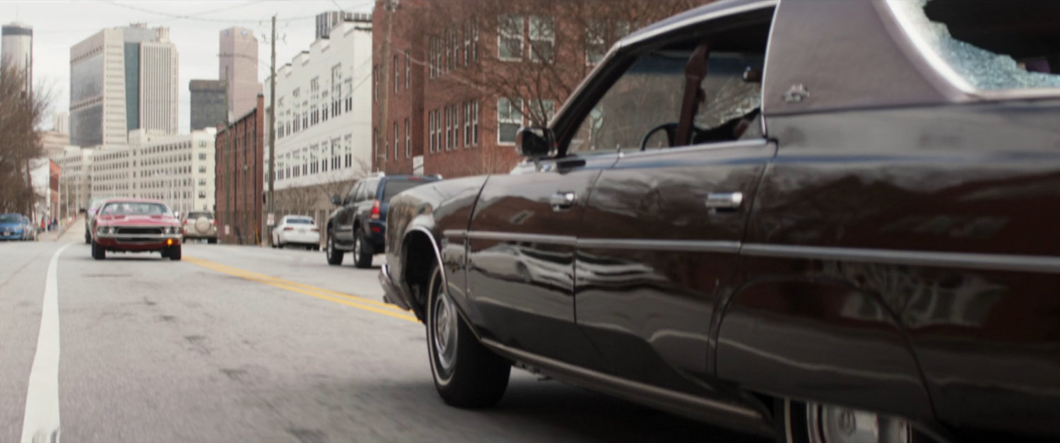 Two cars driving head to head.