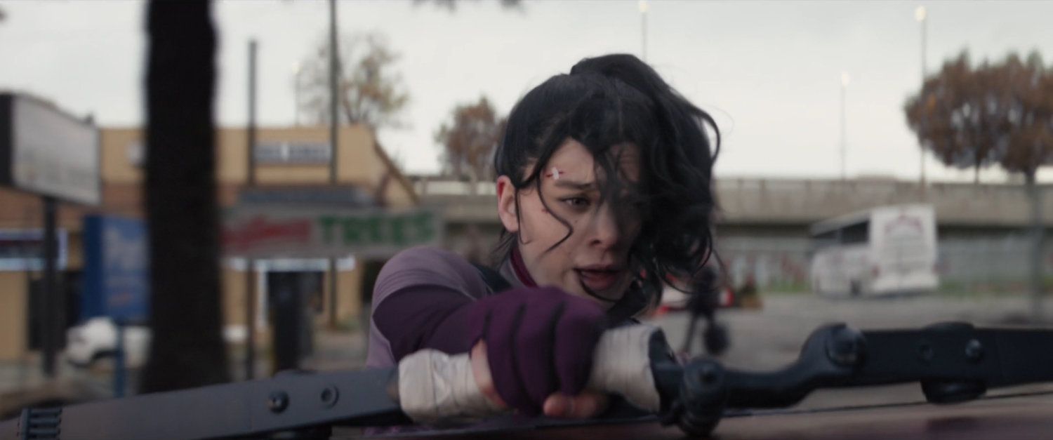 Kate leaning out of a car window.