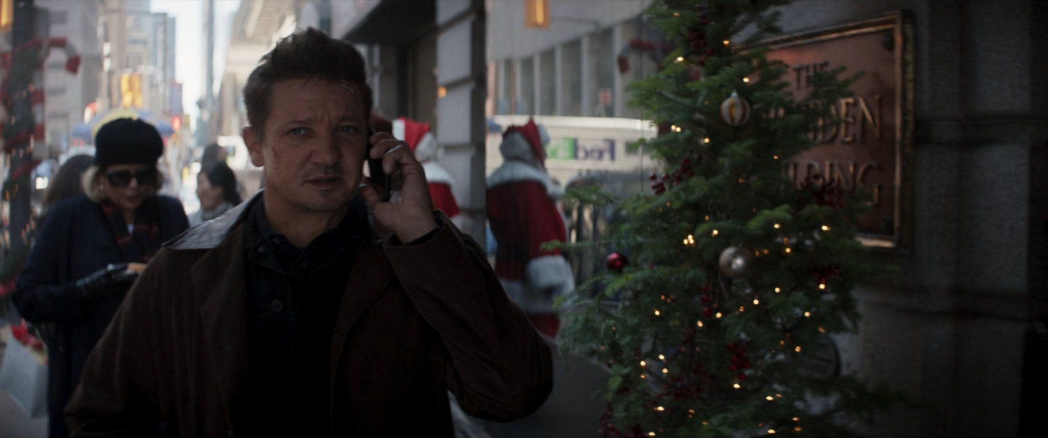 Clint talking on phone while walking on a New York sidewalk.