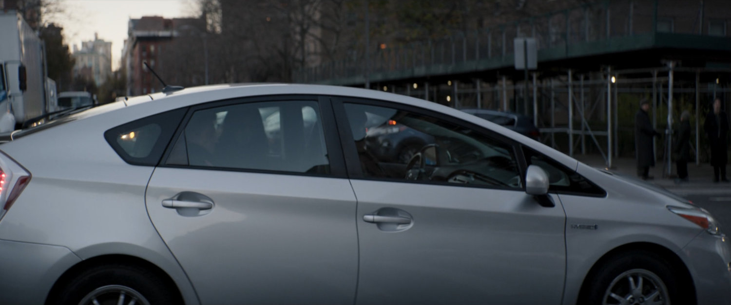 A Prius parked by the side of a New York street.
