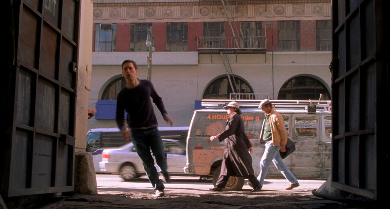 Peter Parker runs into alley.