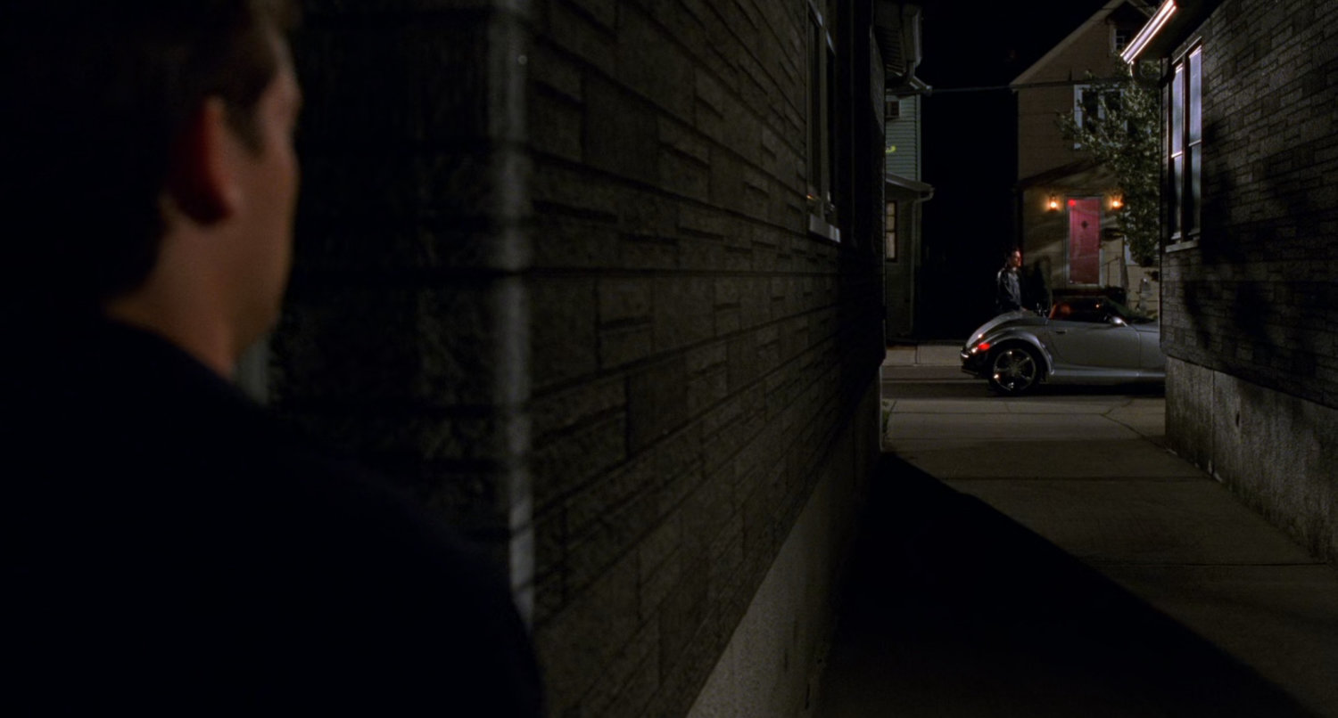 Back alley behind Peter Parker house at night.