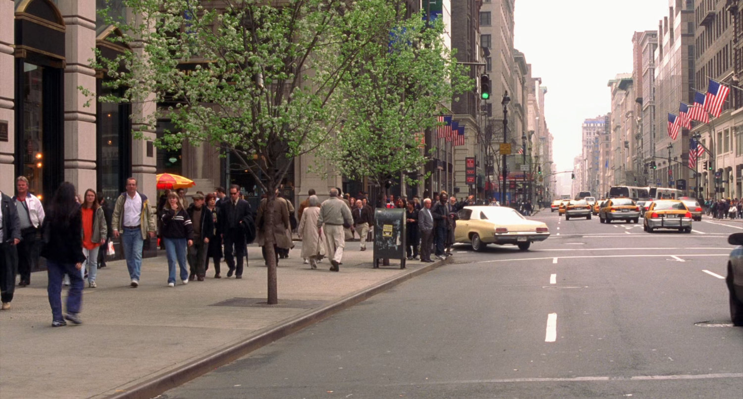 Car turning corner on New York street.