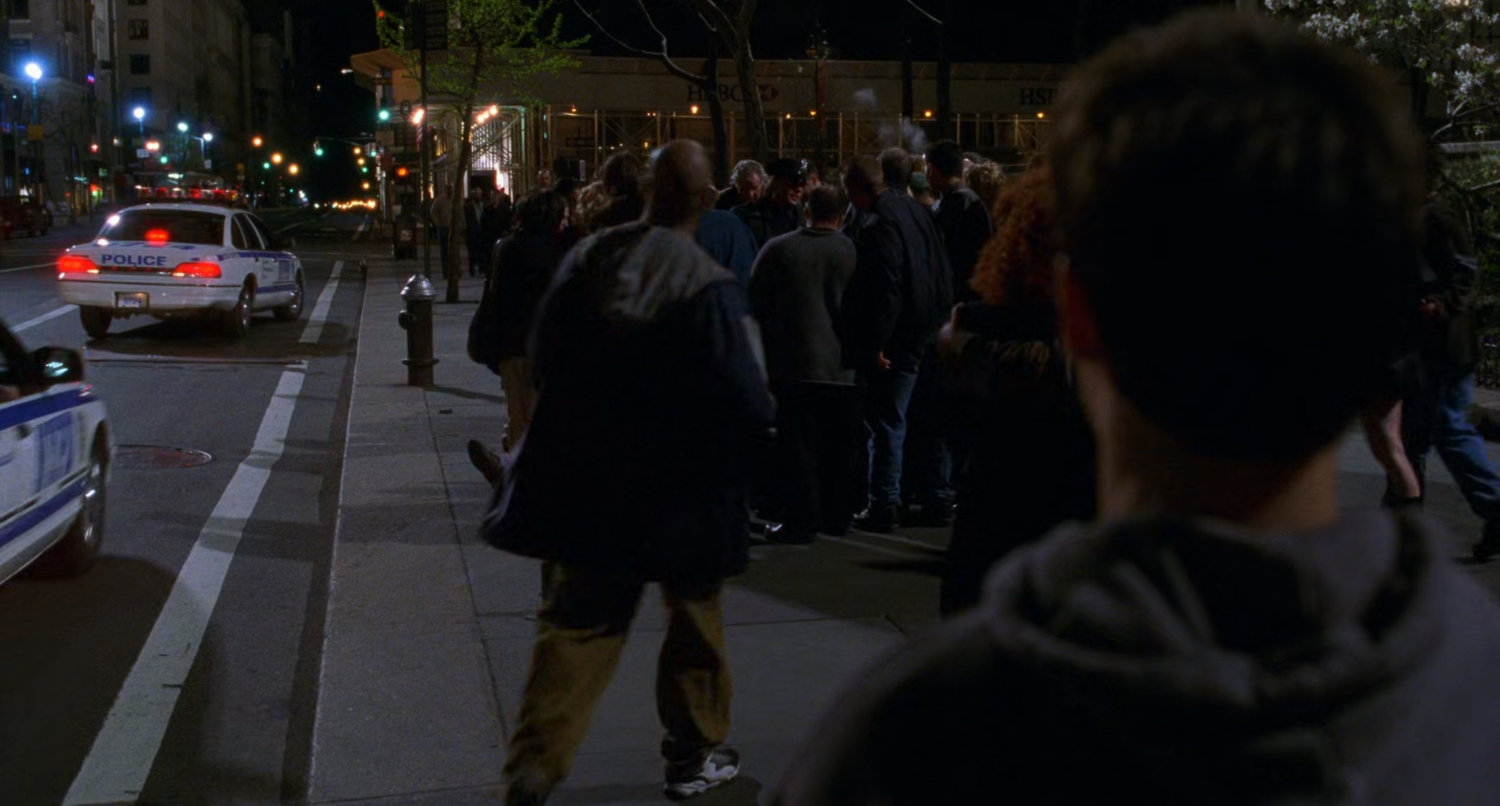 Crowd on sidewalk.