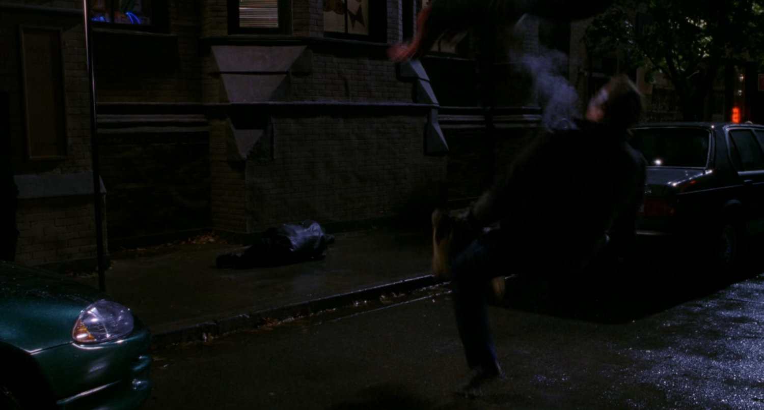 Spider-Man apprehends armored car robber.