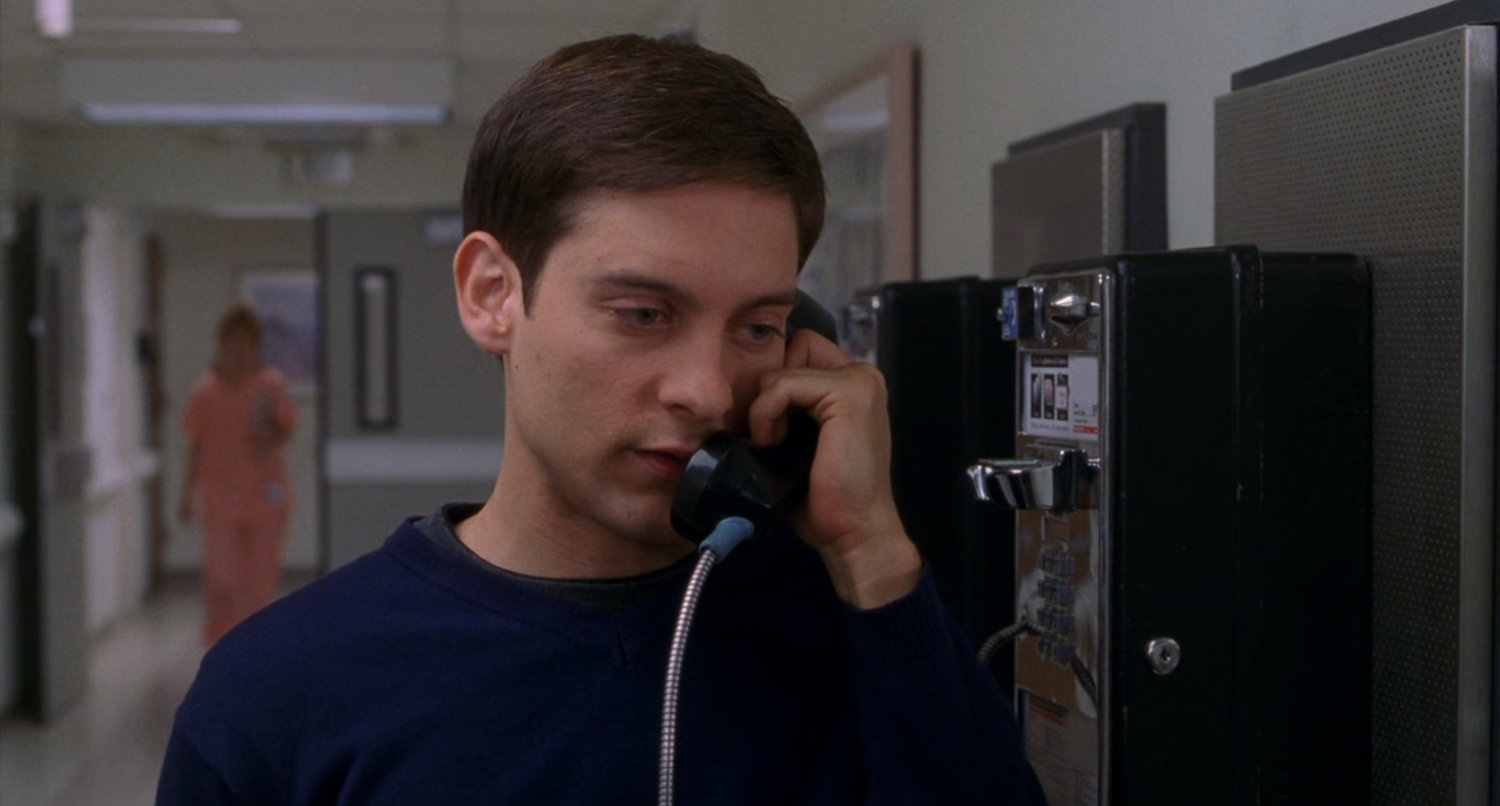 Peter Parker on pay phone in hospital.