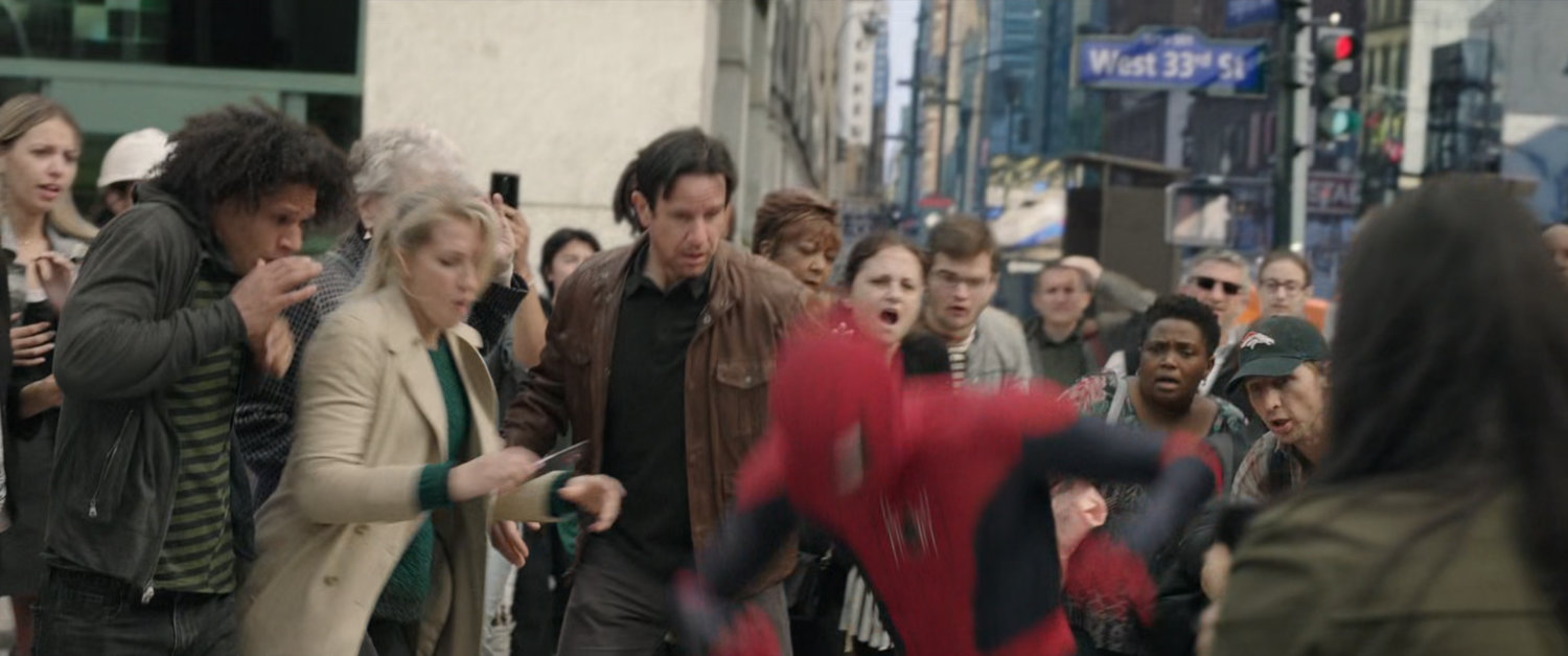 Spider-Man and MJ are harassed by crowds at the entrance to the Penn Station subway.