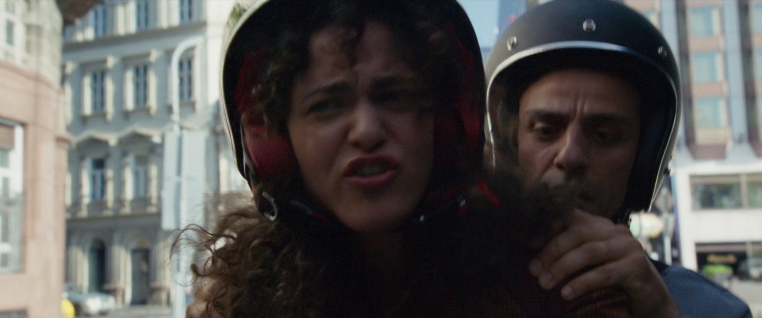 Layla and Steven on moped on London street.