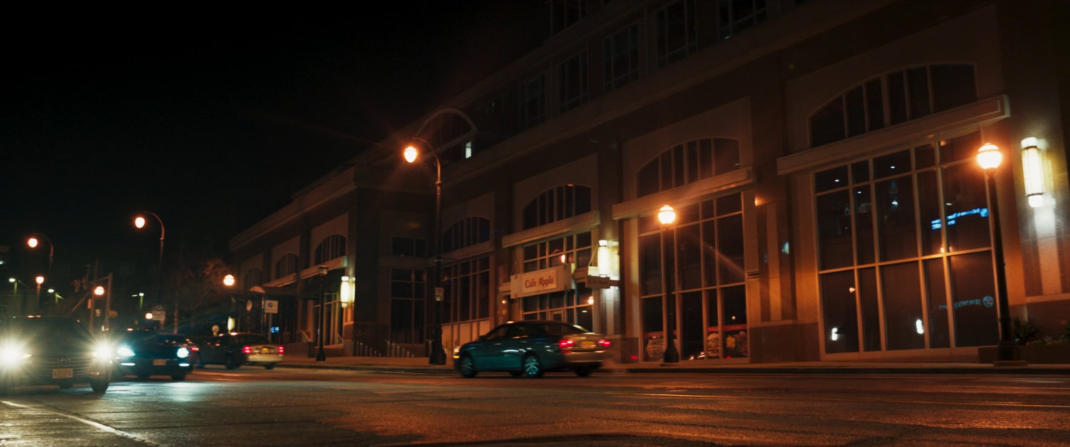 Exterior of building at night on Jersey City street.