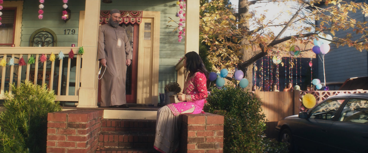 Kamala and the Iman on the front porch of the Khan house.