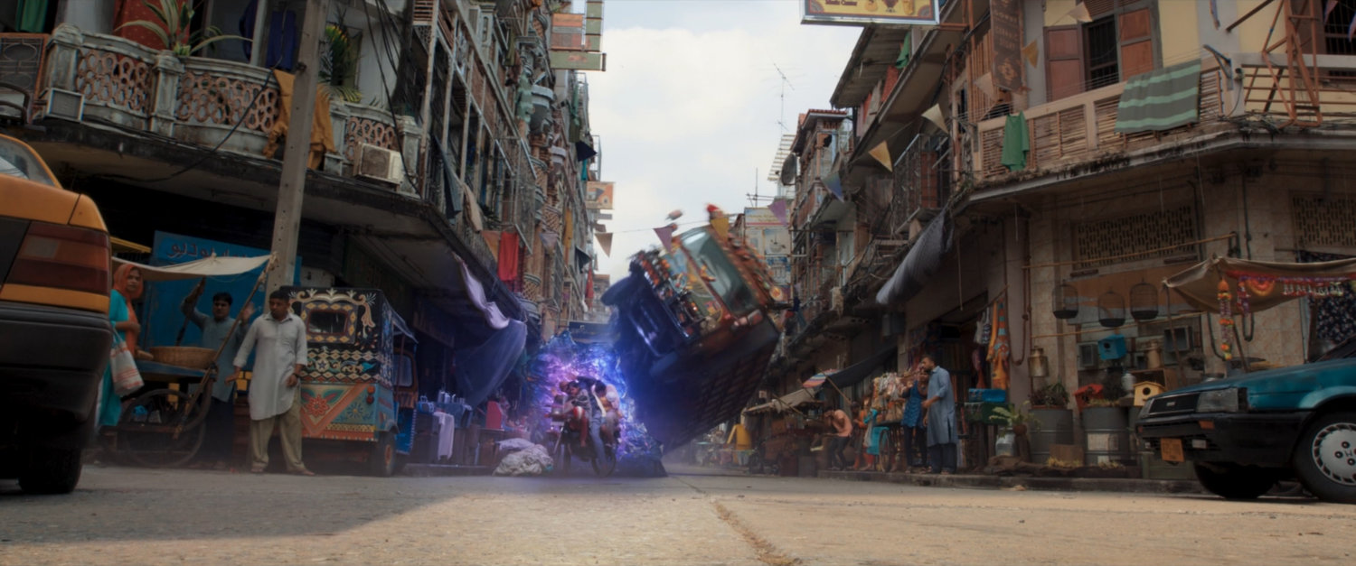 Kamala makes a ramp of hard light to flip a Super Savari tourist bus.