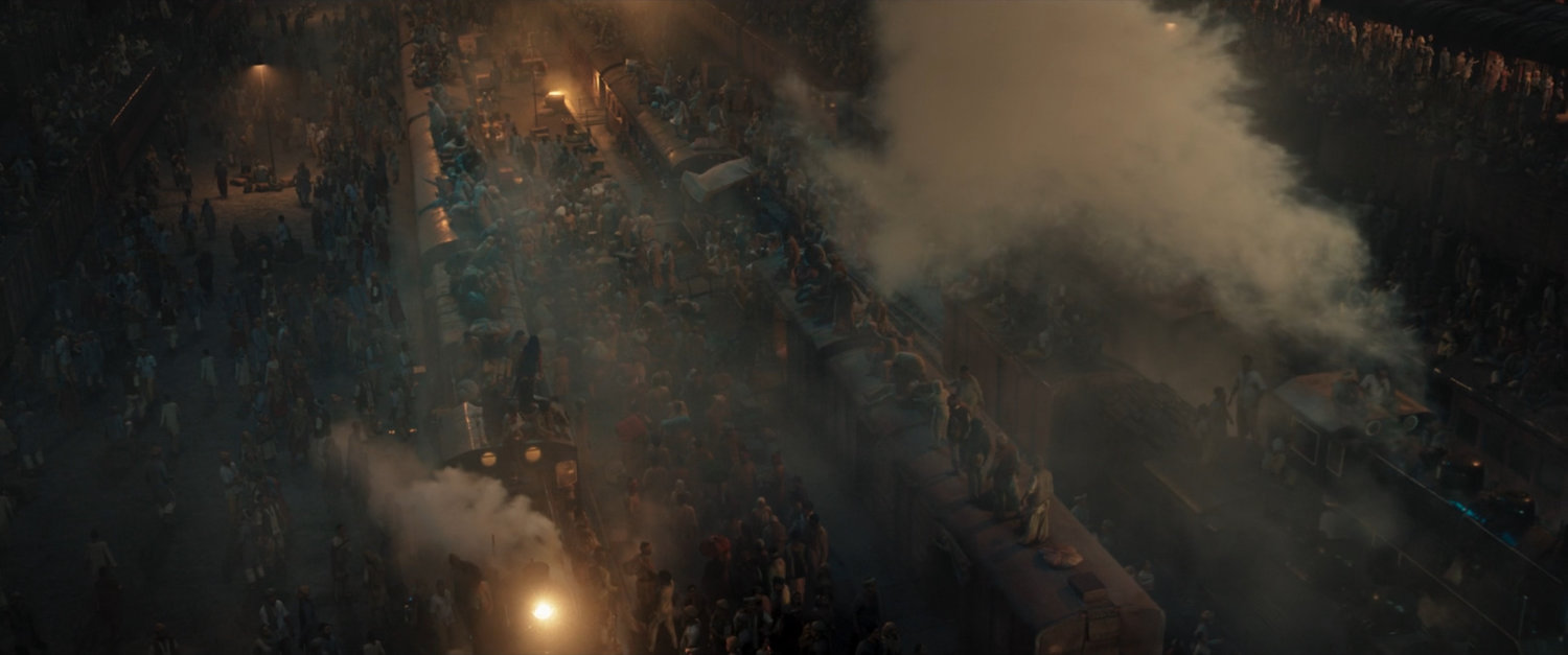 People crowd on and around trains at Indian Railways Train Station.