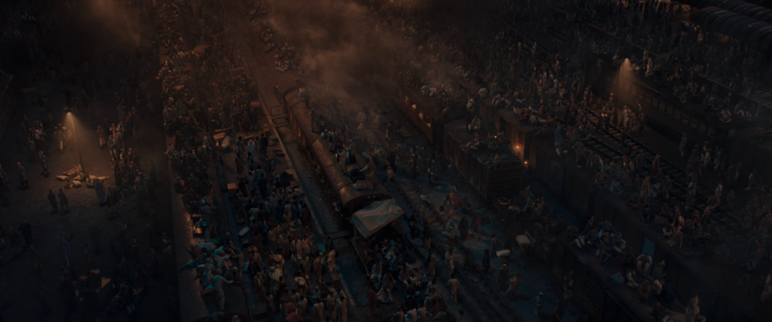 People crowd on and around trains at Indian Railways Train Station.
