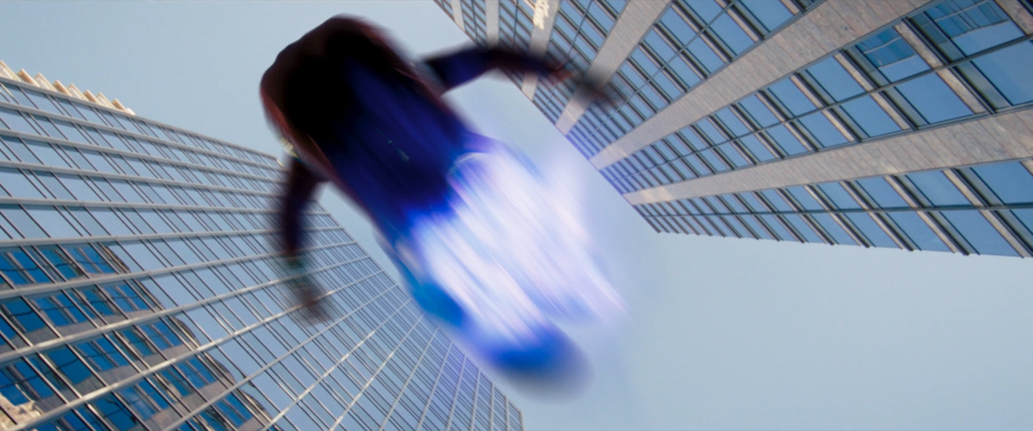 Ms Marvel runs past on platforms of hard light.