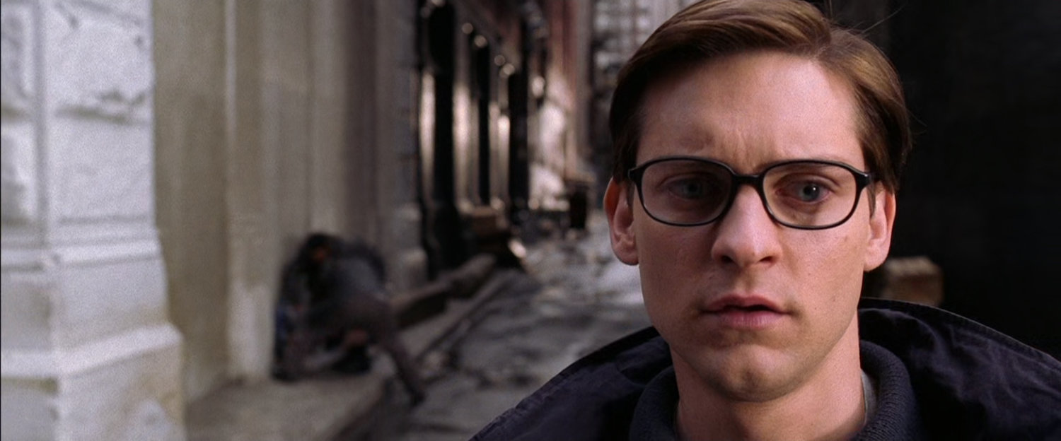 Peter Parker ignoring mugging in alley.